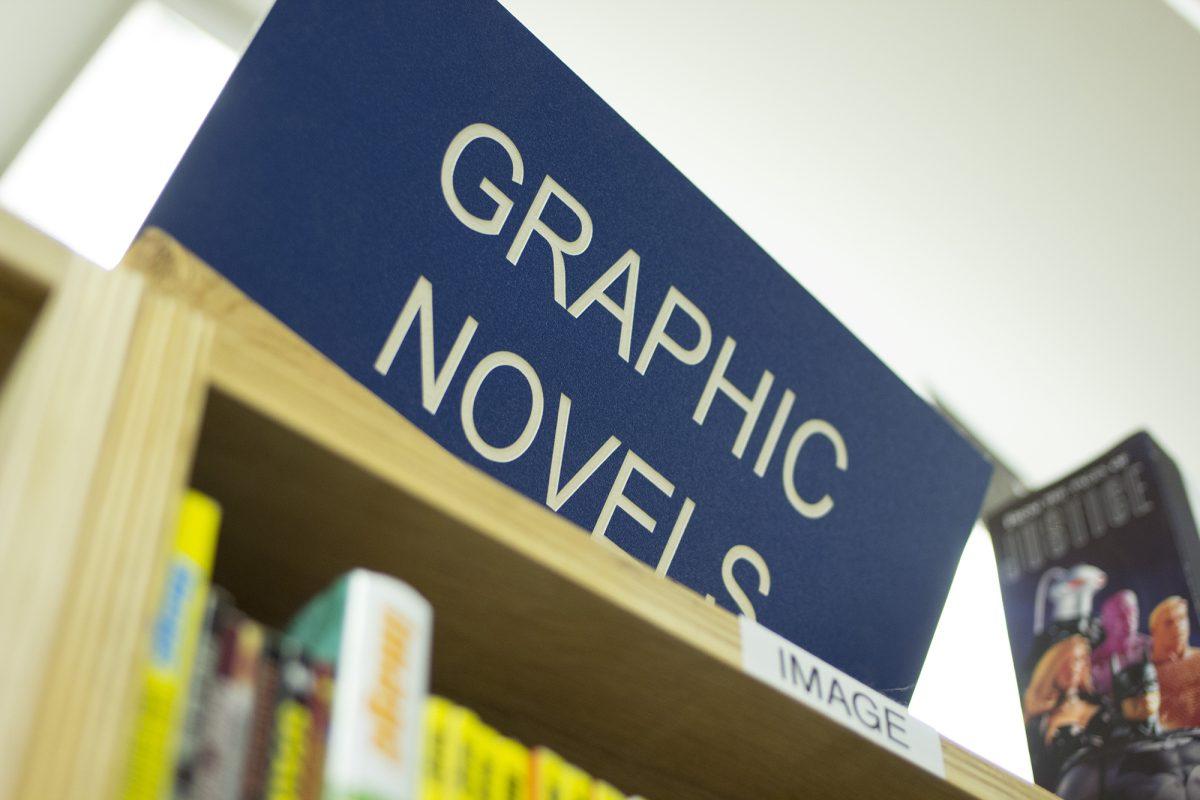 A sign at McKay's Used Books, CDs, Movies and More marks the section where comic lovers can be found.