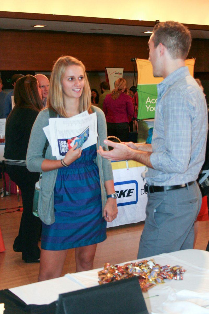 Summer Palmer, a sophomore studying audiology, receives information from a Knoxville employer at the Part-time Job Fair in the University Center on Sept. 4.