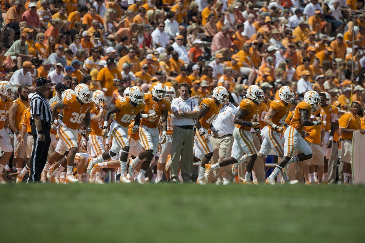 Tennessee head coach Butch Jones watches the special teams unit run onto the field during the team's matchup with Western Kentucky at Neyland Stadium on Saturday, Sept.7