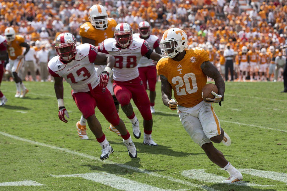 Tennessee running back Rajion Neal runs past Western Kentucky defenders at Neyland Stadium on Saturday, Sept. 7.