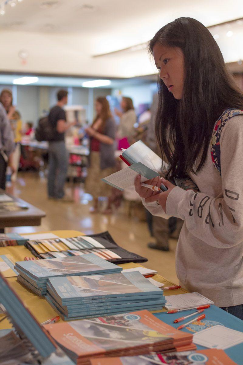 Freshman Lucy Schulz looks over print materials at the Study Abroad Fair on Sept. 25.