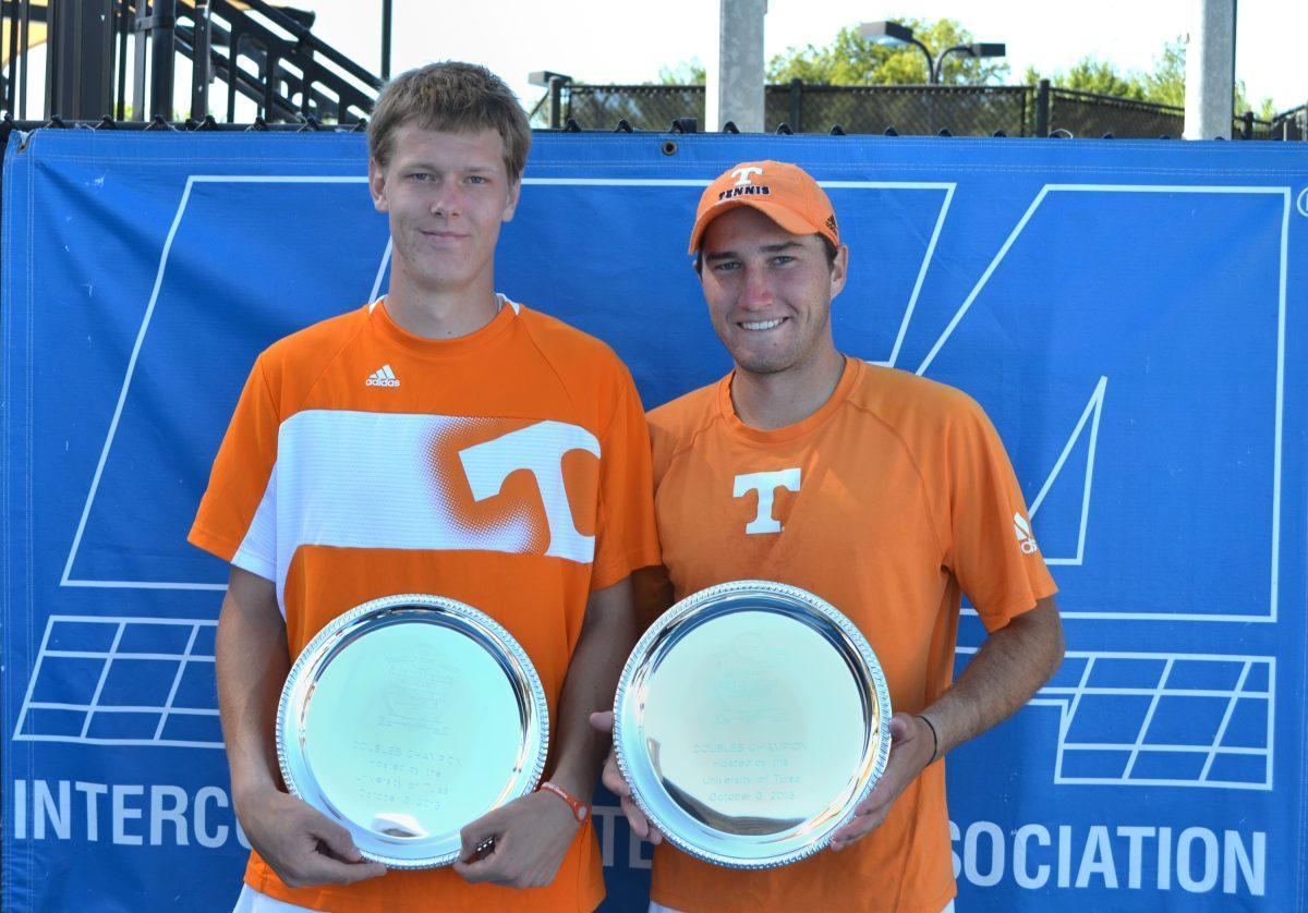 Juniors Mikelis Libietis, left, and Hunter Reese hold their doubles national championship trophies after claiming victory during the ITA All-American Championships in Tulsa, Okla. on Oct. 6.