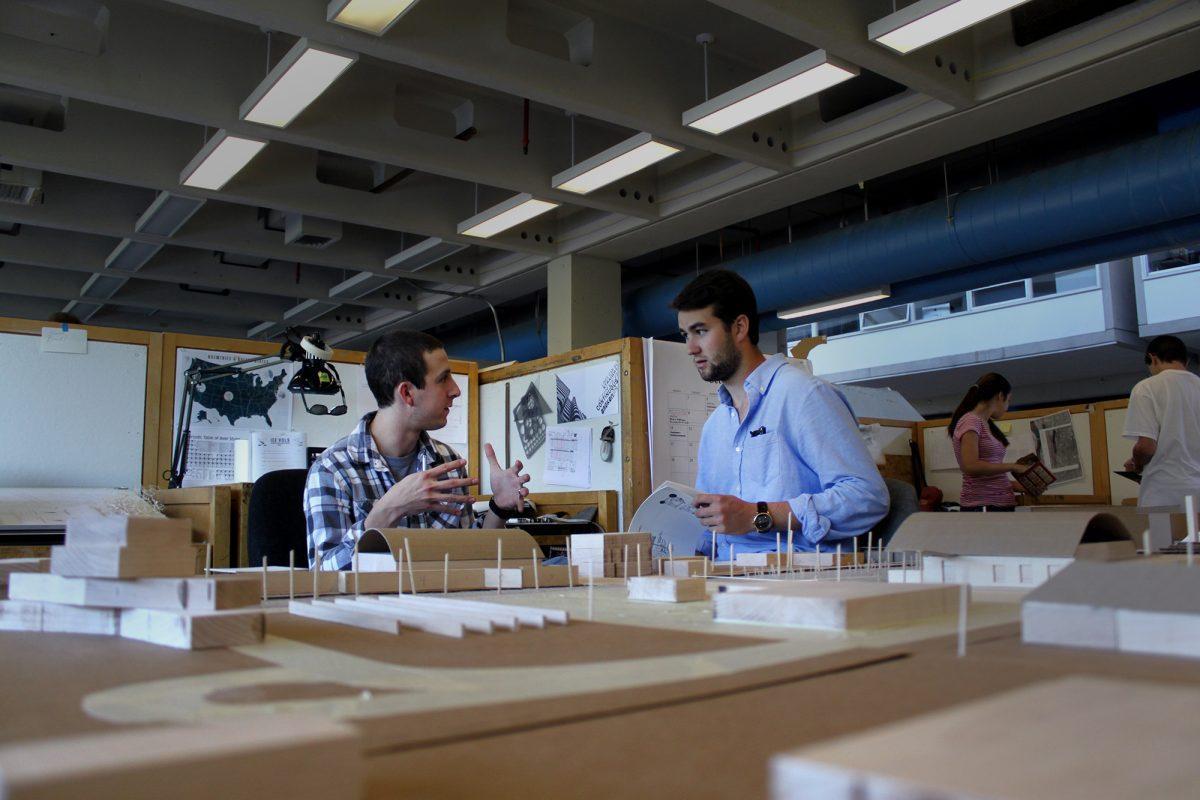 Site models provide insight for Reid Cimala, left, and Collin Cope, right, on an energy-efficient architecture project on Oct. 9.