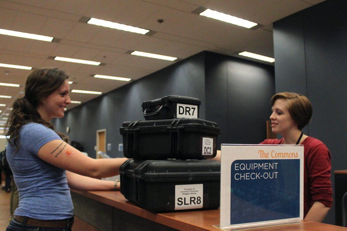 Kaitlin Beitz, left, acquires digital recording tools from Carly Duckett at the equipment check-out desk in the South Commons on Oct. 15.