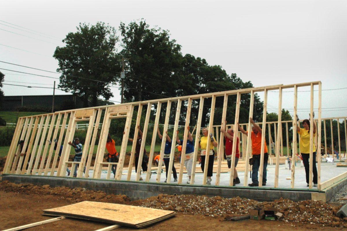 Volunteers erect a wall of the Sertoma Center as a part of WBIR's Labor of Love project.