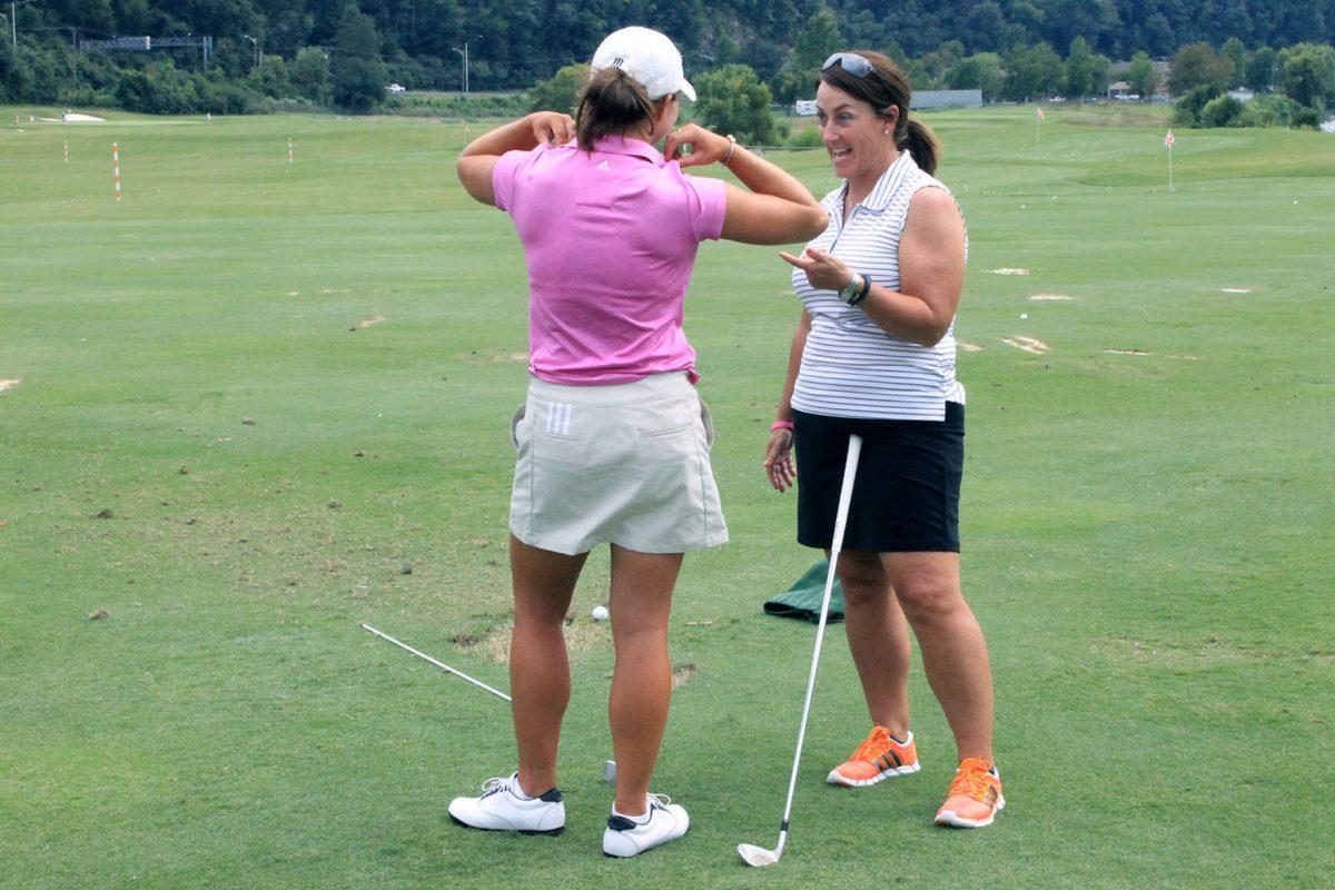 Jodi Pavon advises Emmie Pietill during practice on Sept. 16. Pietill is a sophmore who has played golf since she was seven years old.