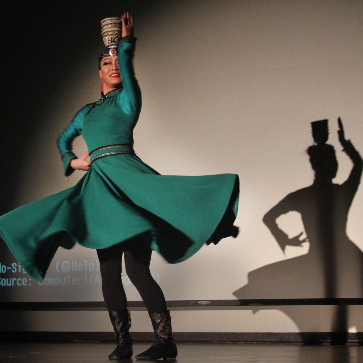 A dancer twirls with a bowl perched atop her head during the Mongolian Dance and Music performances at the UC on Sept. 30.