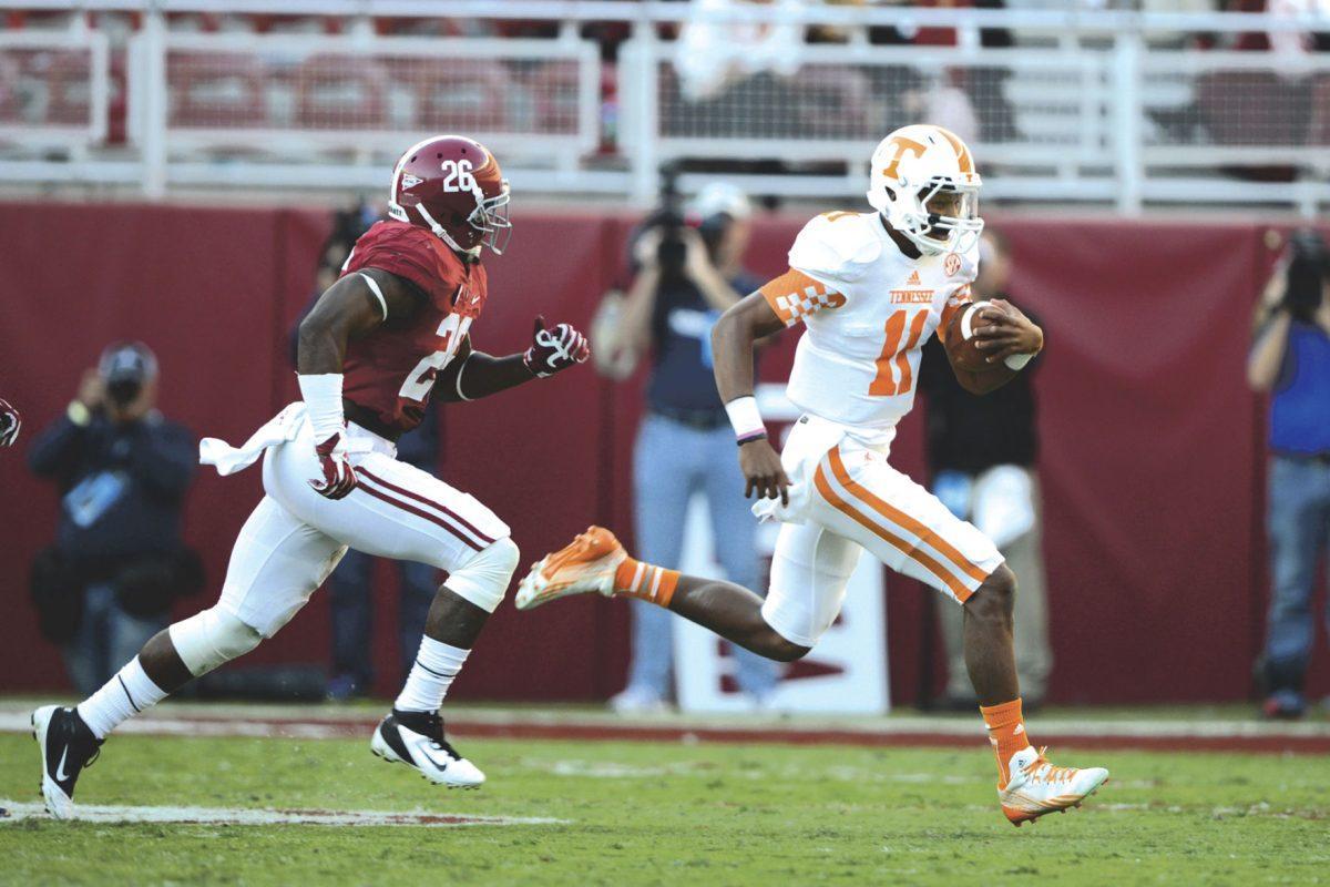 Tennessee true freshman quarterback Josh Dobbs narrowly outruns Alabama safety Landon Collins en route to an 11-yard carry during UT's 45-10 loss against Alabama at Bryant-Denny Stadium on Saturday.
