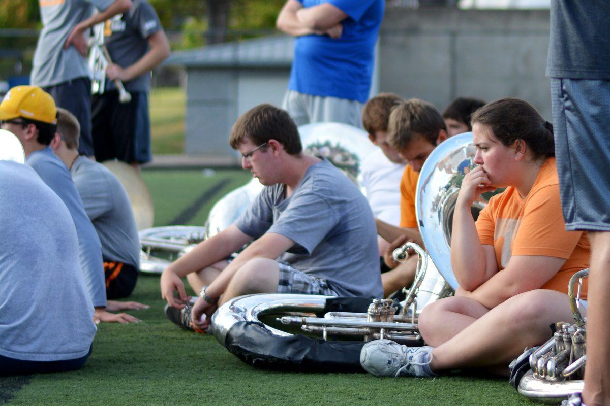 Members of the Pride of the Southland Band look on as interim director Don Ryder speaks to the band after Tuesday's practice at the intramural fields. Prior to practice, UT announced it was placing current director of bands Gary Sousa on administrative leave.