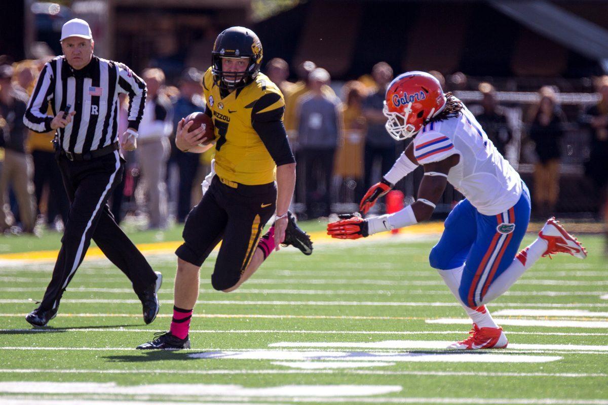 Missouri redshirt freshman quarterback Maty Mauk runs around Florida linebacker Neiron Ball during a game on Oct. 19. Mauk is filling in for senior quarterback James Franklin, who has missed the last two games due to a separated shoulder.