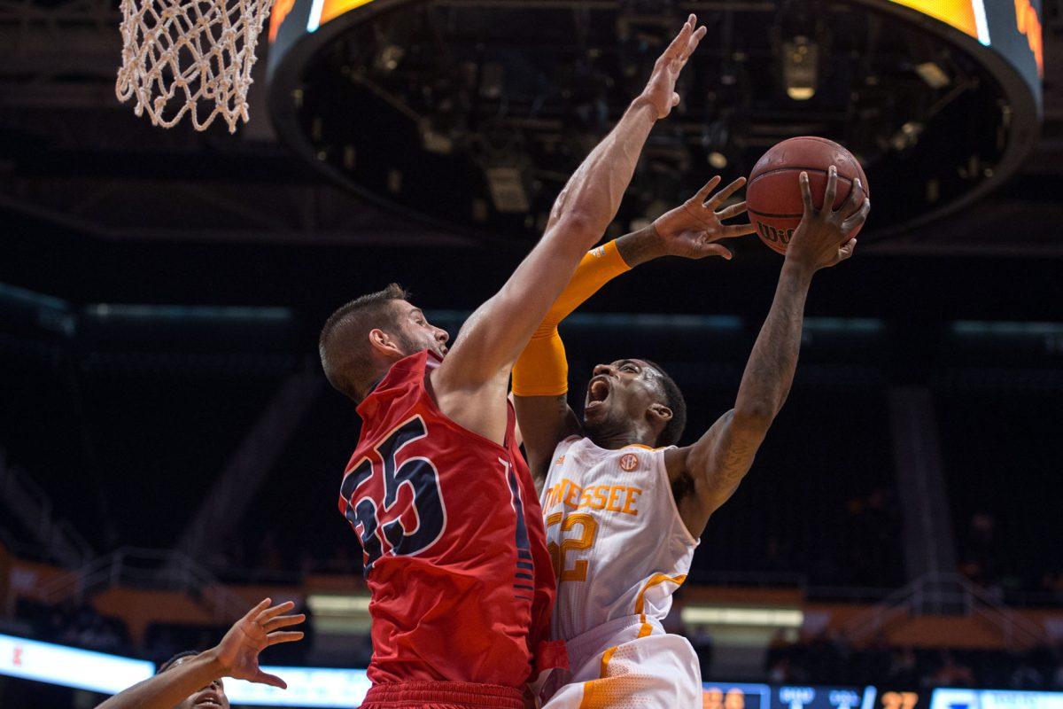 Tennessee senior guard Jordan McRae (52) shoots a lay-up over Southern Indiana center Chuck Davis (55) during an exhibition game at Thompson-Boling Arena on Thursday.