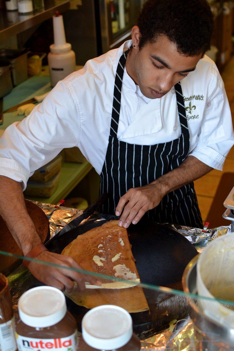 James Weleski, a new employee at The French Market on Gay Street, prepares crêpes for customers on Wednesday.