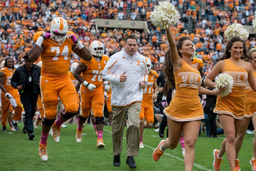 Tennessee coach Butch Jones runs out of the "T" with his team before UT's game against South Carolina at Neyland Stadium on Oct. 19.