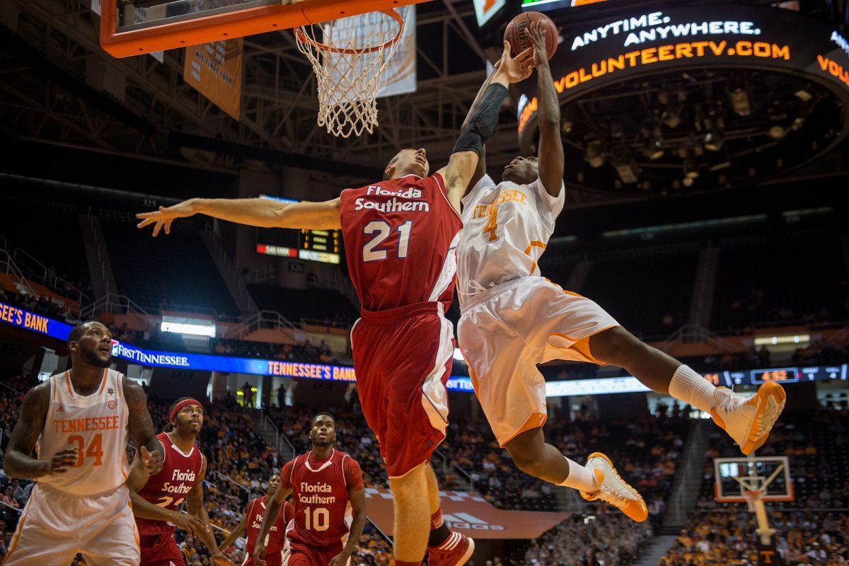 Armani Moore shoots while the Florida Southern's Stephen Turner defends the hoop on Nov. 2.