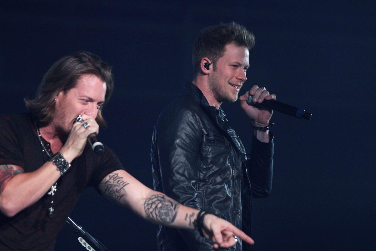 Tyler Hubbard, left, and Brian Kelley of Florida Georgia Line sing to fans in the Knoxville Civic Center on Saturday. FGL attempted to endear itself to fans by showing an appreciation of Knoxville history and culture.