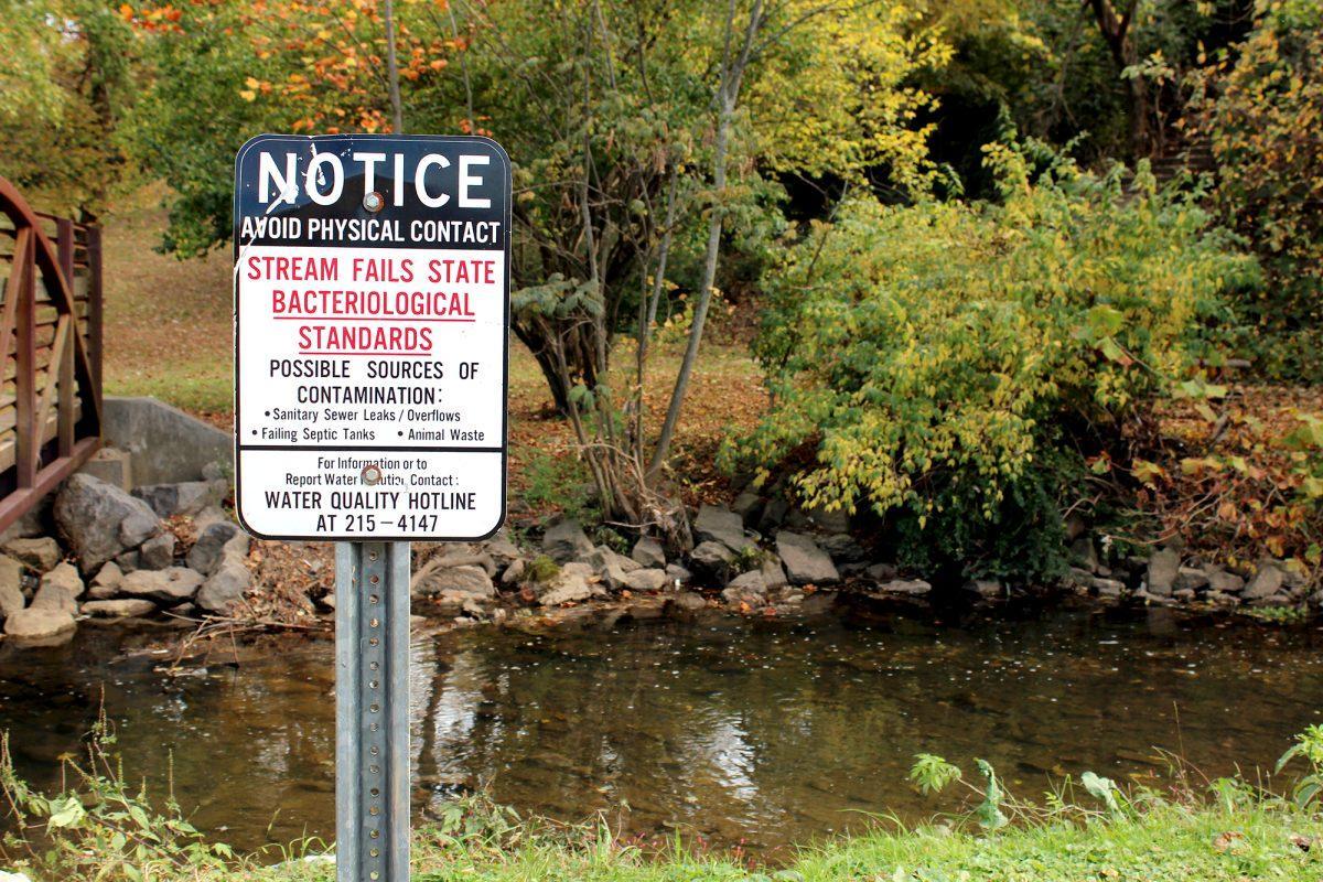 A sign warns visitors of the water quality in the Tyson McGhee River behind The Tower at Morgan Hills apartments.