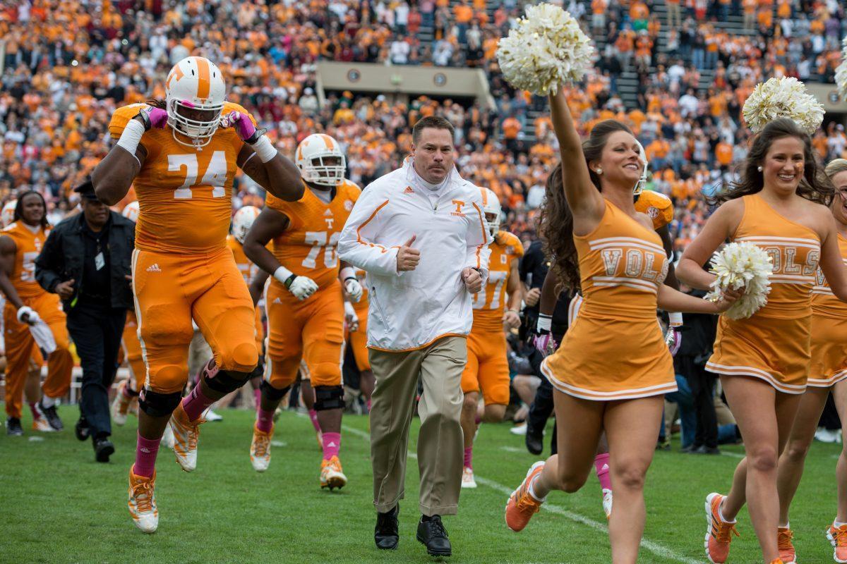 Tennessee coach Butch Jones runs out of the "T" with his team before UT's game against South Carolina at Neyland Stadium on Oct. 19.
