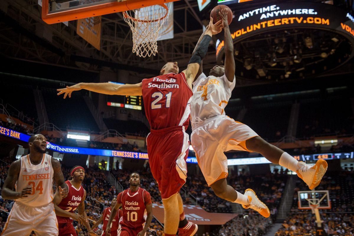 Armani Moore shoots while the Florida Southern's Stephen Turner defends the hoop on Nov. 2.