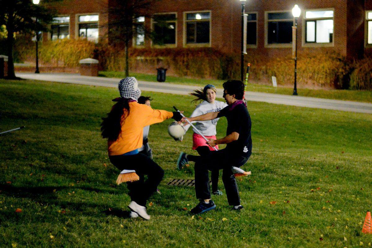 Students practice quidditch in the HSS Amphitheater on Wednesday. The game, inspired by the "Harry Potter" series, requires participants to carry a broom at all times.