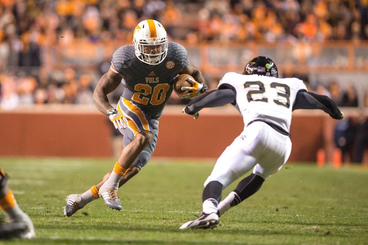Tennessee senior running back Rajion Neal prepares to lower his shoulder against Vanderbilt's Andre Hal during the Commodores' 14-10 win at Neyland Stadium on Saturday.