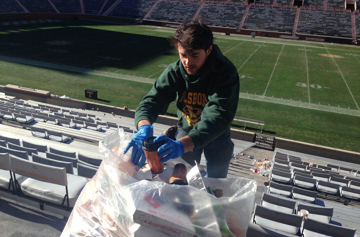Robert Fischman, sophomore in nutrition and member of the Outdoor Program, assists in the cleanup of Neyland Stadium on Nov. 24.
