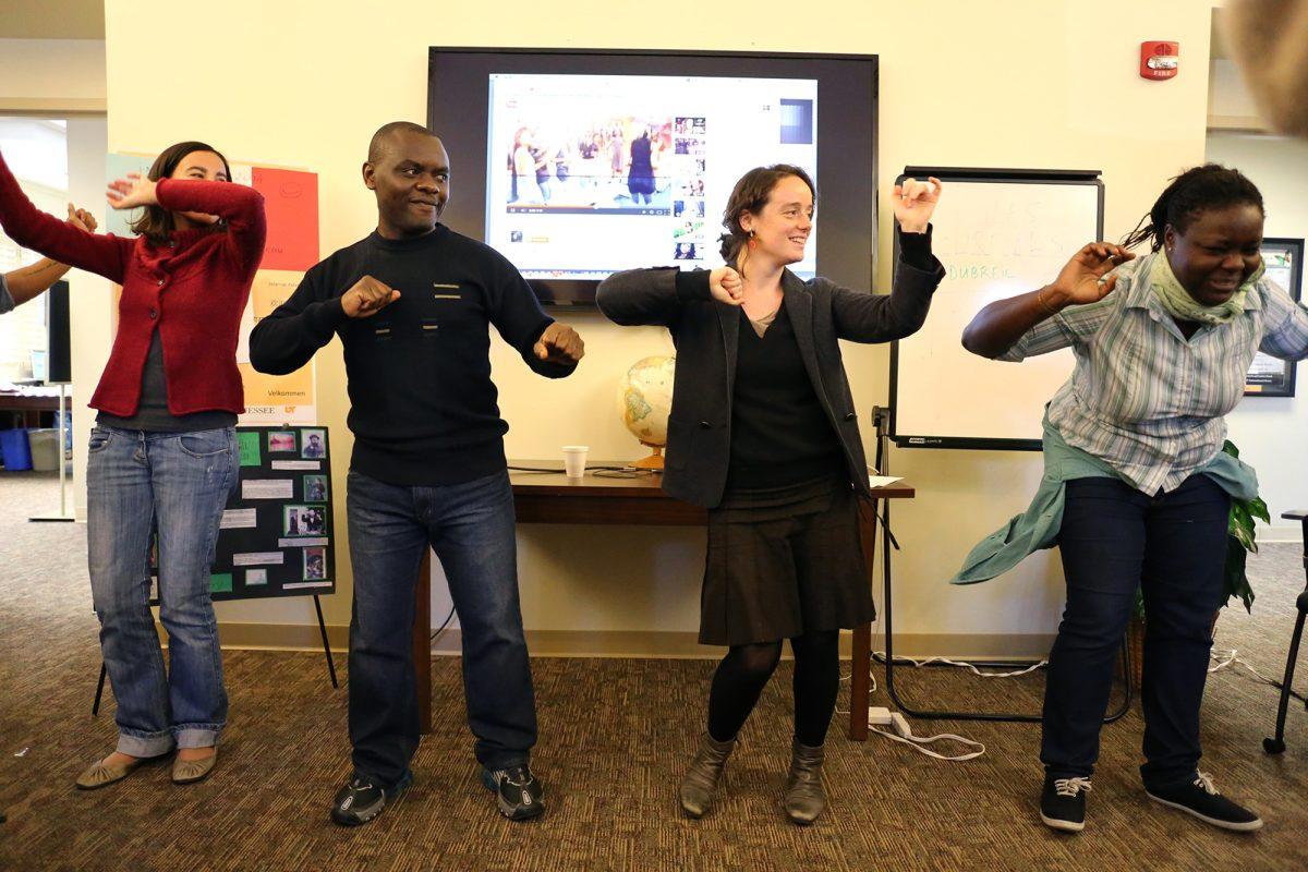 Beatrice Flamenbaum, left, Gerard Keubeung Fokou, left middle, Joanna Merkel, right middle, and Falone Domle Jiejup dance on Nov. 14 at the International House during its French Cultural Day.