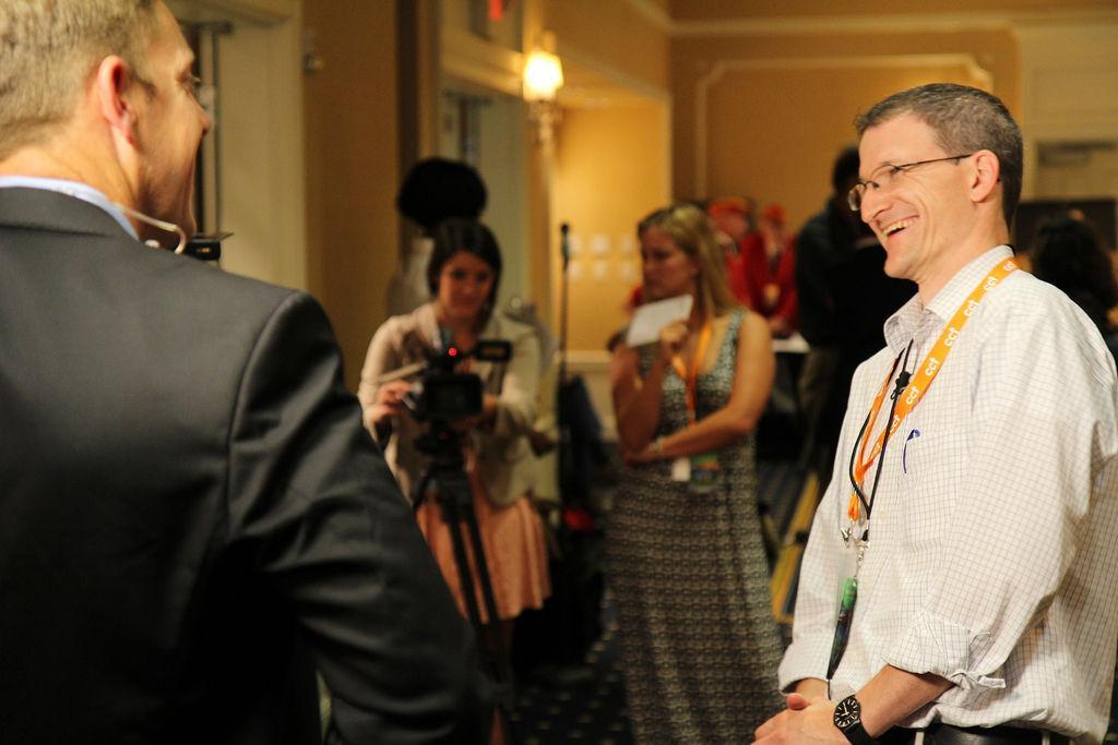 Nick Geidner, assistant professor of journalism and electronic media, talks with attendees at the 2013 Medal of Honor Convention in Gettysburg, Pa. Students Jackie Delpilar, back left, and Taylor Hathorn, back right, work the camera to capture the moment.