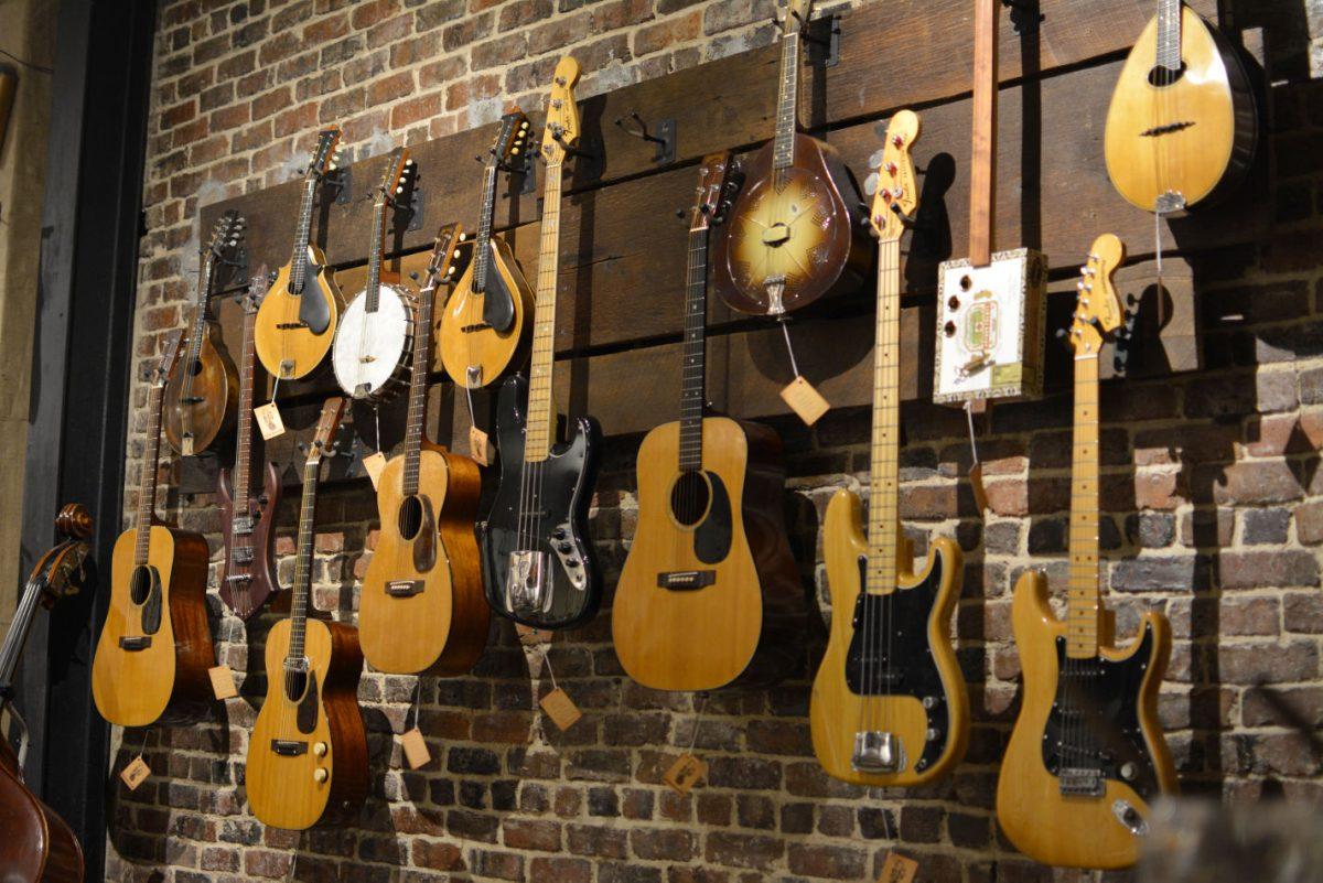 Beacon Mandolins, banjos, acoustic and electric guitars of all shapes and sizes display against the wall inside The Parlor on Jan. 29.