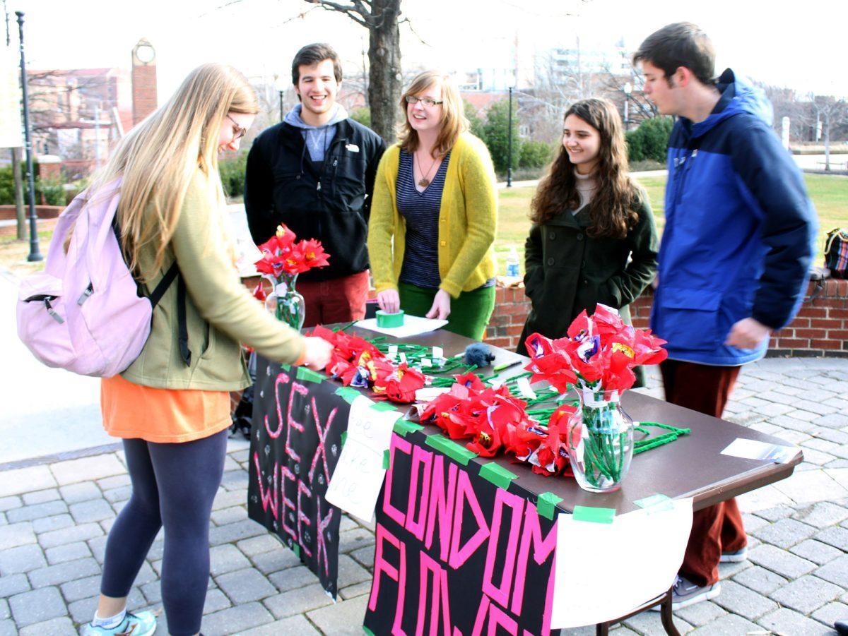 Leslie Cox, left, then a senior in journalism and electronic media, gathers information about Sex Week on Valentine's Day 2013.
