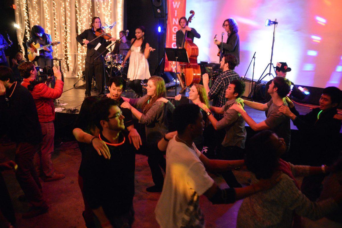 The crowd forms a conga line as the gypsy jazz players of Swingbooty perform on Jan. 25 at the Relix Theatre.