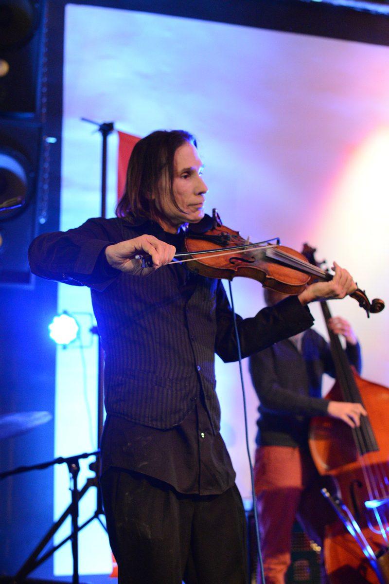 Christian Lange, a violinist for gypsy jazz band Swingbooty, performs with the band Oroboro and VolatomiX breakdancers at the Relix Theatre on Jan. 25.