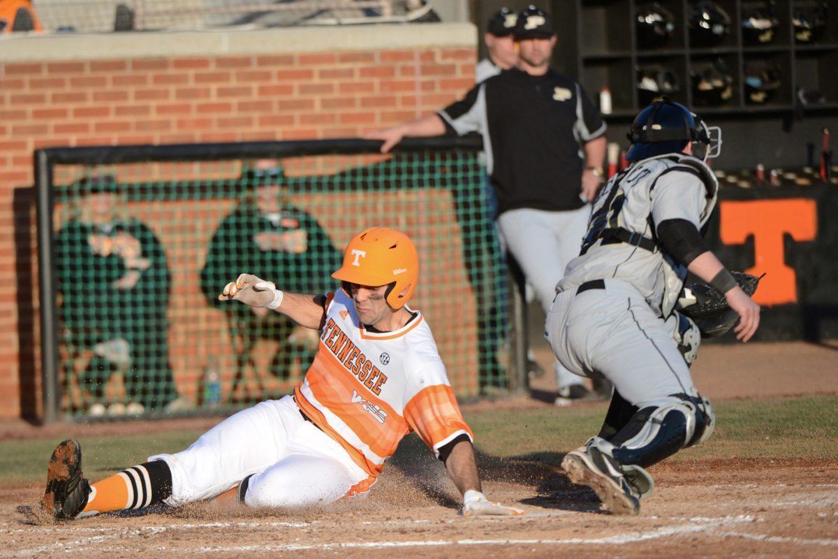 Senior outfielder Scott Price slides safely into home in the Vols' 20-2 victory over the Purdue Boilermakers in the second game of their doubleheader at Lindsey Nelson Stadium on Sunday.