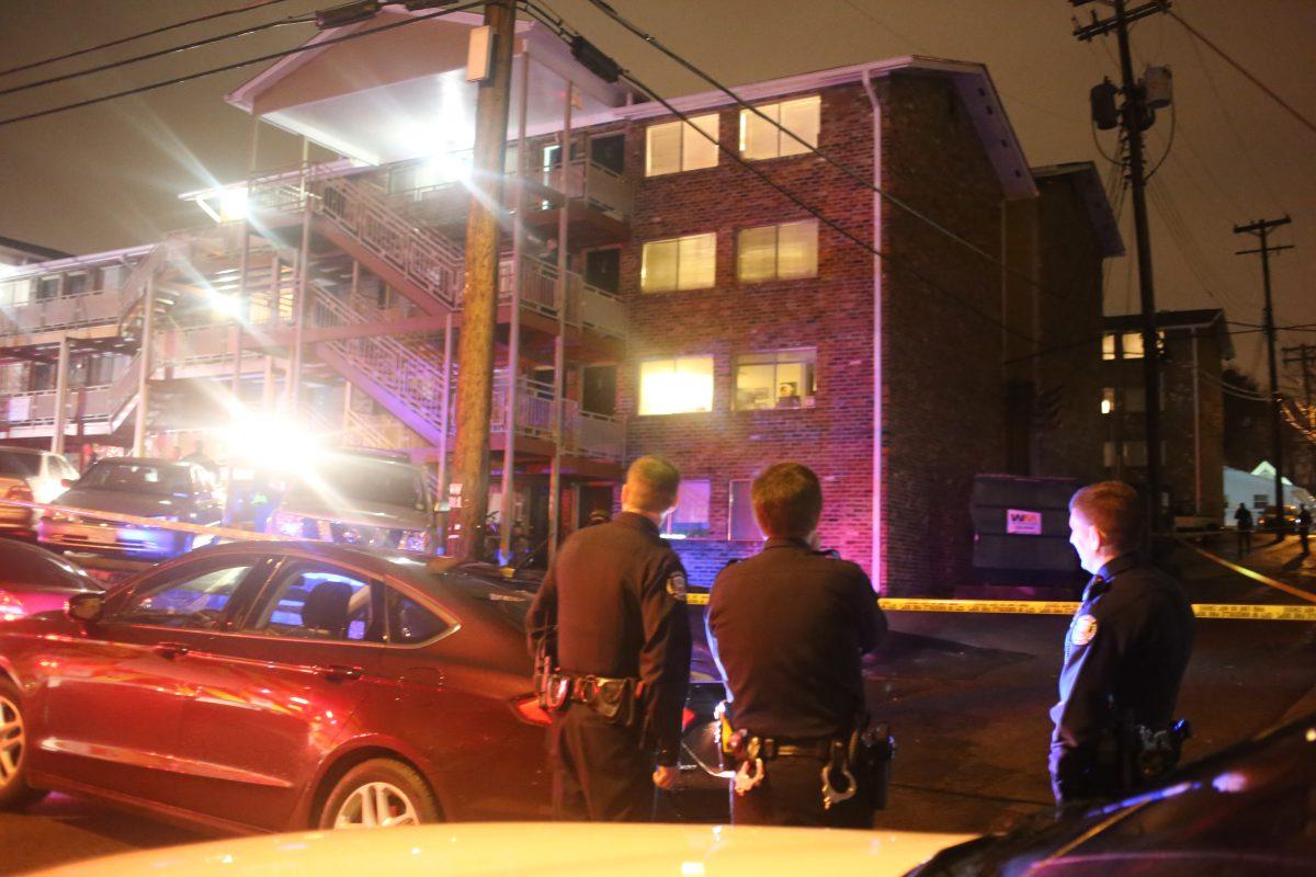 Knoxville Police Department officers look up at apartment No. 20 of the Highland Terrace complex where a male and female victim were found shot on Tuesday night. A third victim was found near 21st street and Highland Avenue. All three victims were transported to University of Tennessee Medical Center and are all expected to recover.