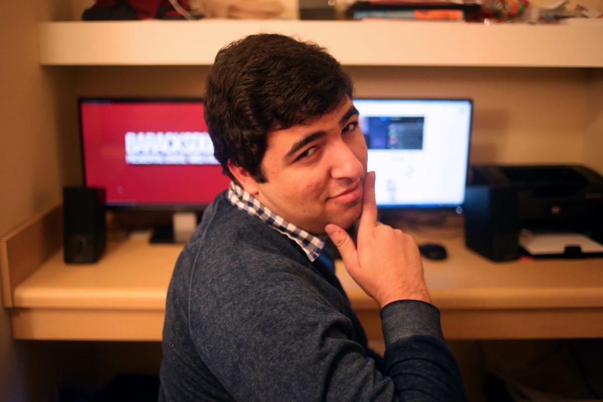 Fadi Saleh, junior in College Scholars, poses for a photo at his desk in the Volunteer Hall apartment. Saleh, the creator of the YouTube channel Baracksdubs, has amassed more than 130 million views on the account by stringing together bits from President Barack Obama's speeches and making the president appear to be singing hit pop songs.