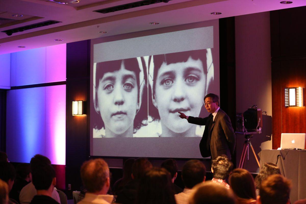 Professor of photography Baldwin Lee uses a photo of identical twins to illustrate the importance of paying attention to detail in a talk entitled "Looking is Harder Than It Looks" at the TEDxUTK Conference inside the Toyota Auditorium on Saturday.