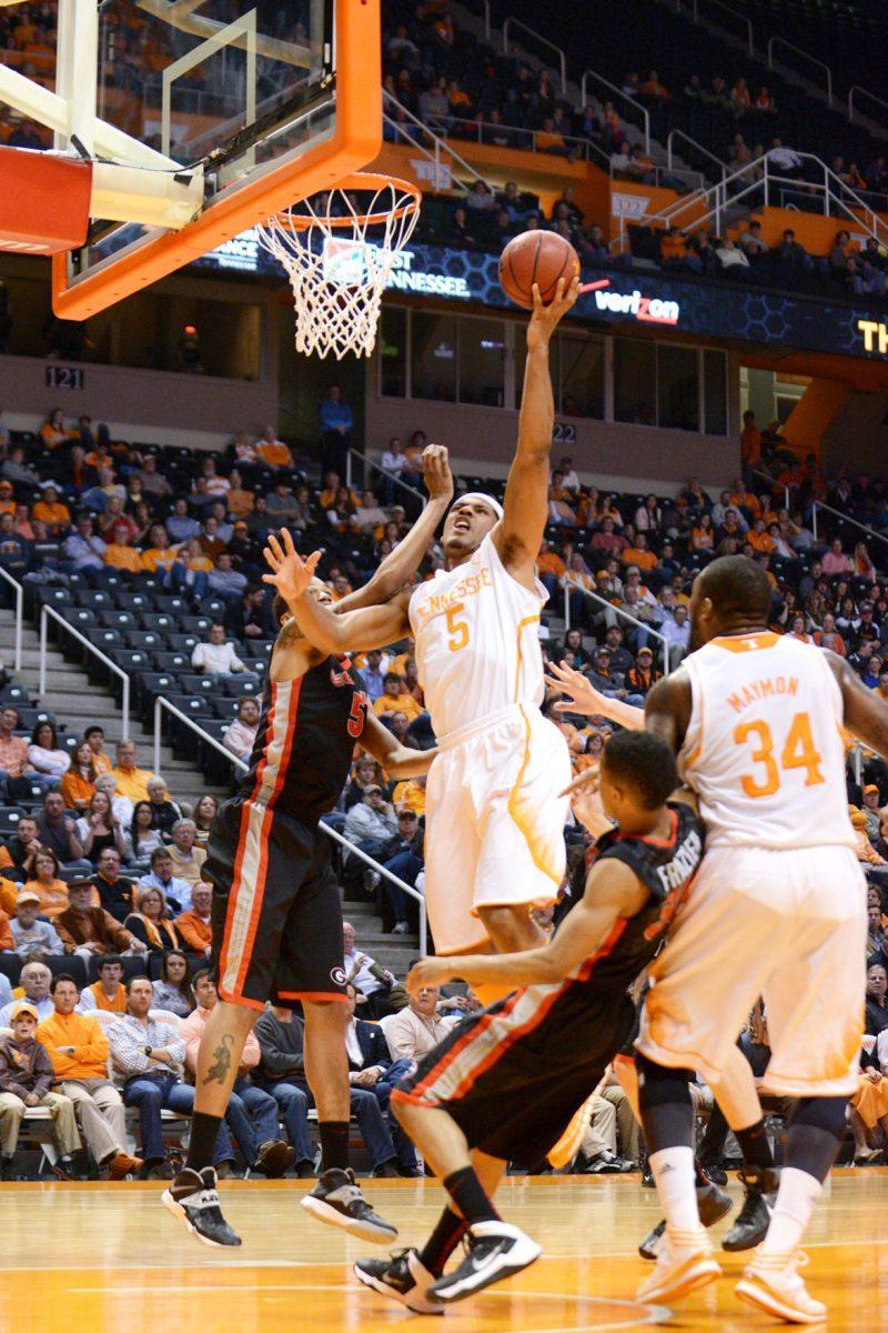 Tennessee junior forward Jarnell Stokes fights past defenders in the lane while putting up a layup in the Vols' 67-48 win over Georgia at Thompson-Boling Arena on Tuesday. Stokes finished with 20 points, 11 rebounds, three blocks and three assists.