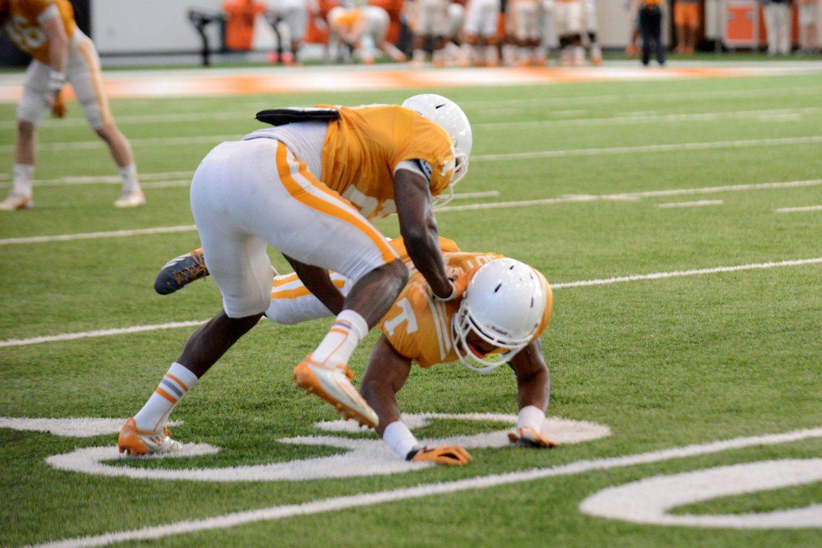 Senior defensive back Justin Coleman, left, practices tackling technique on a teammate during UT's fourth spring practice inside the Neyland-Thompson Sports Complex on Thursday.