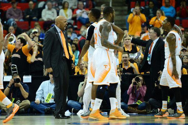 Tennessee head coach Cuonzo Martin lets out a celebratory roar as Josh Richardson, back middle, chest bumps Jordan McRae and Jeronne Maymon, front middle, and Antonio Barton, right, celebrate during the Vols' 83-63 second-round NCAA tournament win over Mercer at PNC Arena on Sunday.