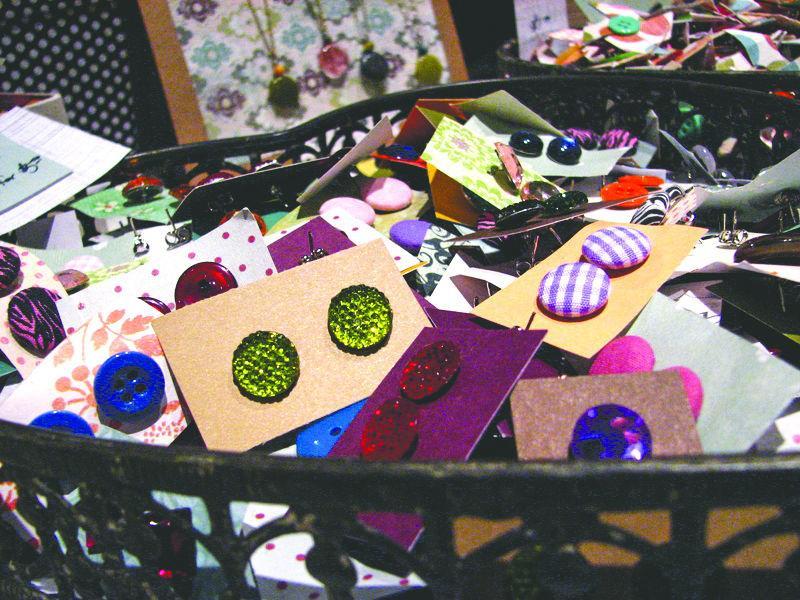 Vendor Chelsea Mello sets up her shop "A Little Something For You" in the Relix Theatre where she sells button or cloth accessories March 29.