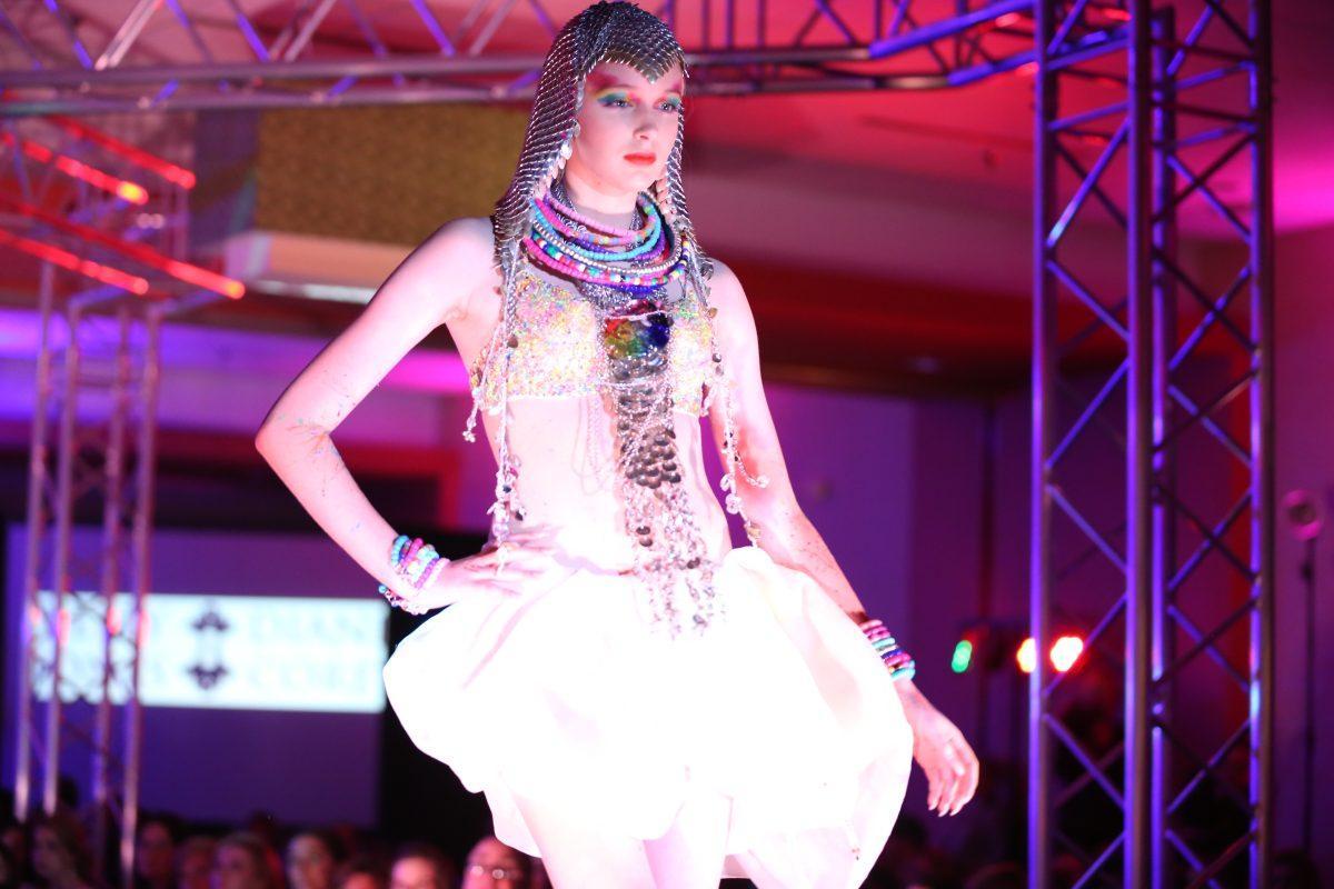 A model wearing Kelly Jones &amp; Diane Corey poses at the end of the runway at Knoxville Fashion Week on Saturday.