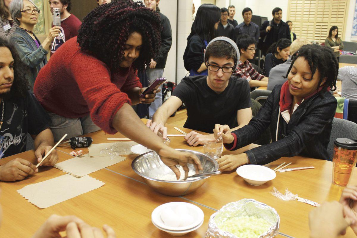 Christine Gidden (left), Tyler Yoner (middle) and Alexandria Green (right), all students in a Japanese class, work on following the Japanese Cooking Demo at the I-House on Tuesday night.