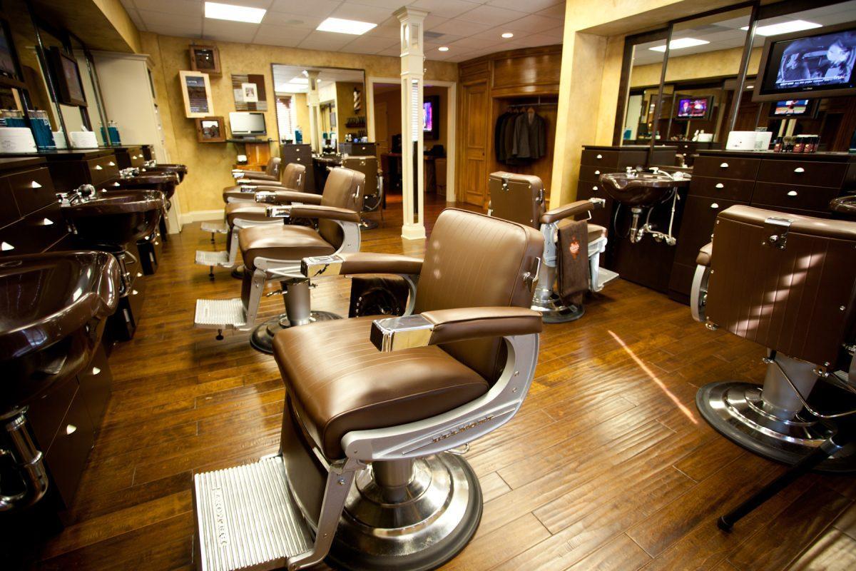 Warm wood paneling and leather-accented interiors invite customers to Frank's Barbershop off Northshore Drive.