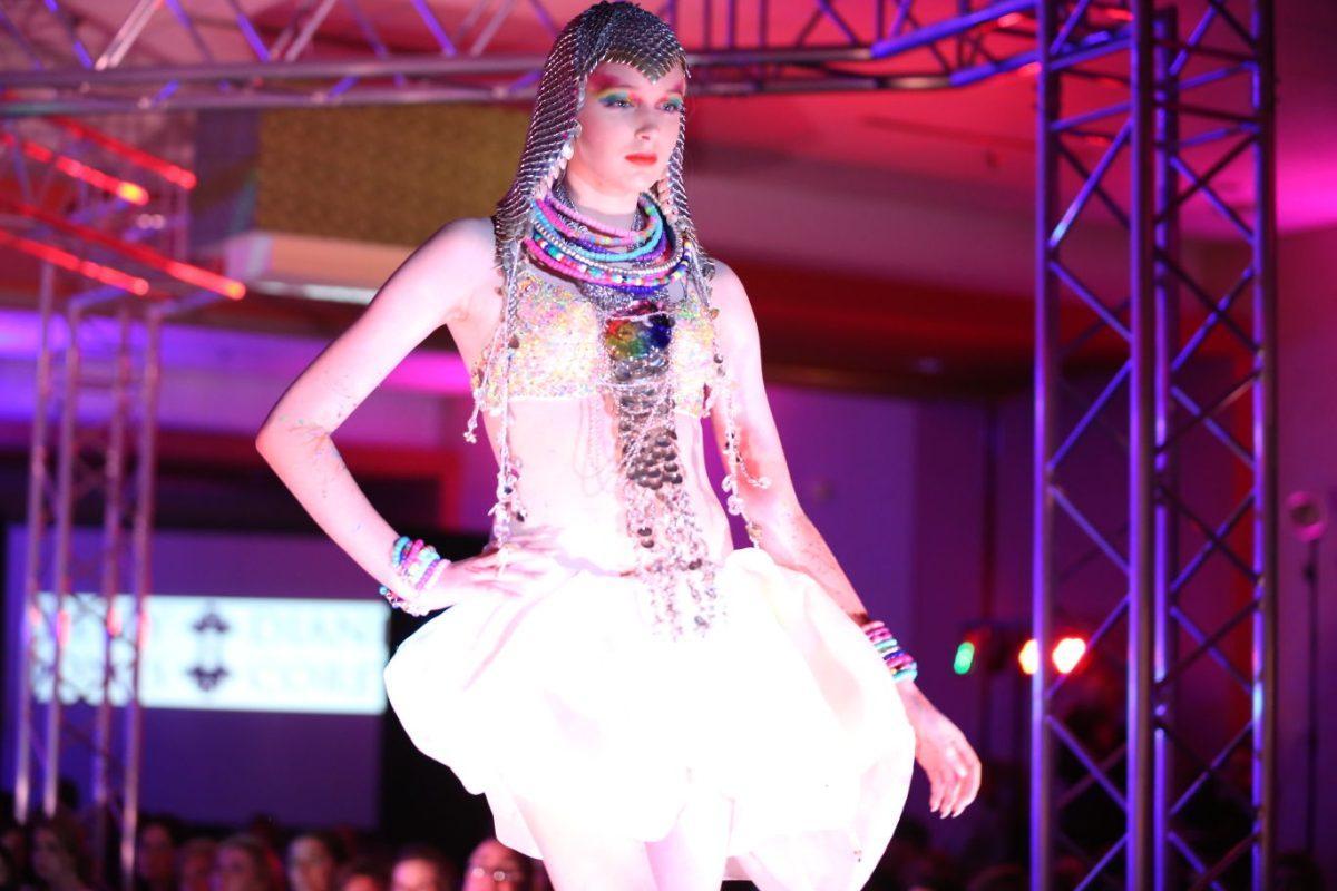 A model wearing Kelly Jones &amp; Diane Corey poses at the end of the runway at Knoxville Fashion Week on Saturday.
