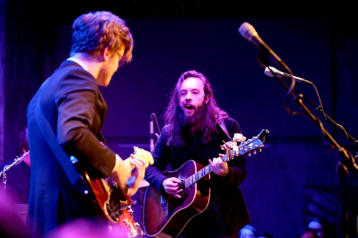 Tyler Anthony, right, front man of folk band Cereus Bright, glimpses over to Evan Ford during the band's performance at The Square Room on Friday.