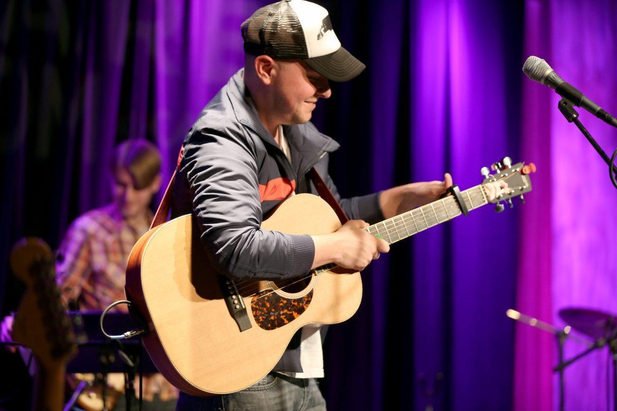 Kurt Layell, guitarist for Time Sawyer, tunes his guitar before performing a song at The Square Room on Friday.
