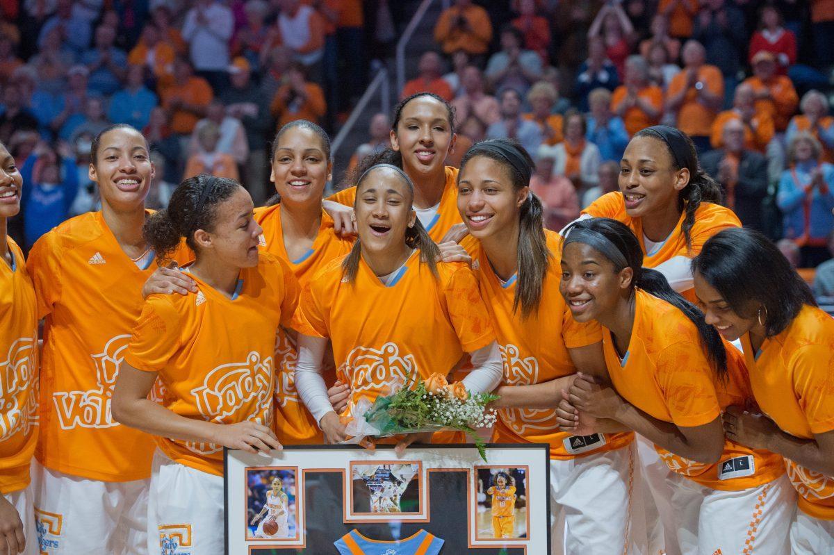Senior Meighan Simmons, center, grins with her teammates during the Senior Day Presentation before UT's game against the No. 4 South Carolina Gamecocks at Thompson-Boling Arena on Sunday. The Vols beat the Gamecocks, 71-63.
