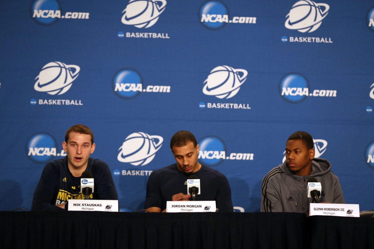Michigan Wolverines players Nik Stauskas, left, Jordan Morgan, center, and Glenn Robinson III, talk to reporters on Thursday at Lucas Oil Stadium in Indianapolis. The Wolverines will take on No. 11 seed Tennessee tonight at 7:15 p.m.