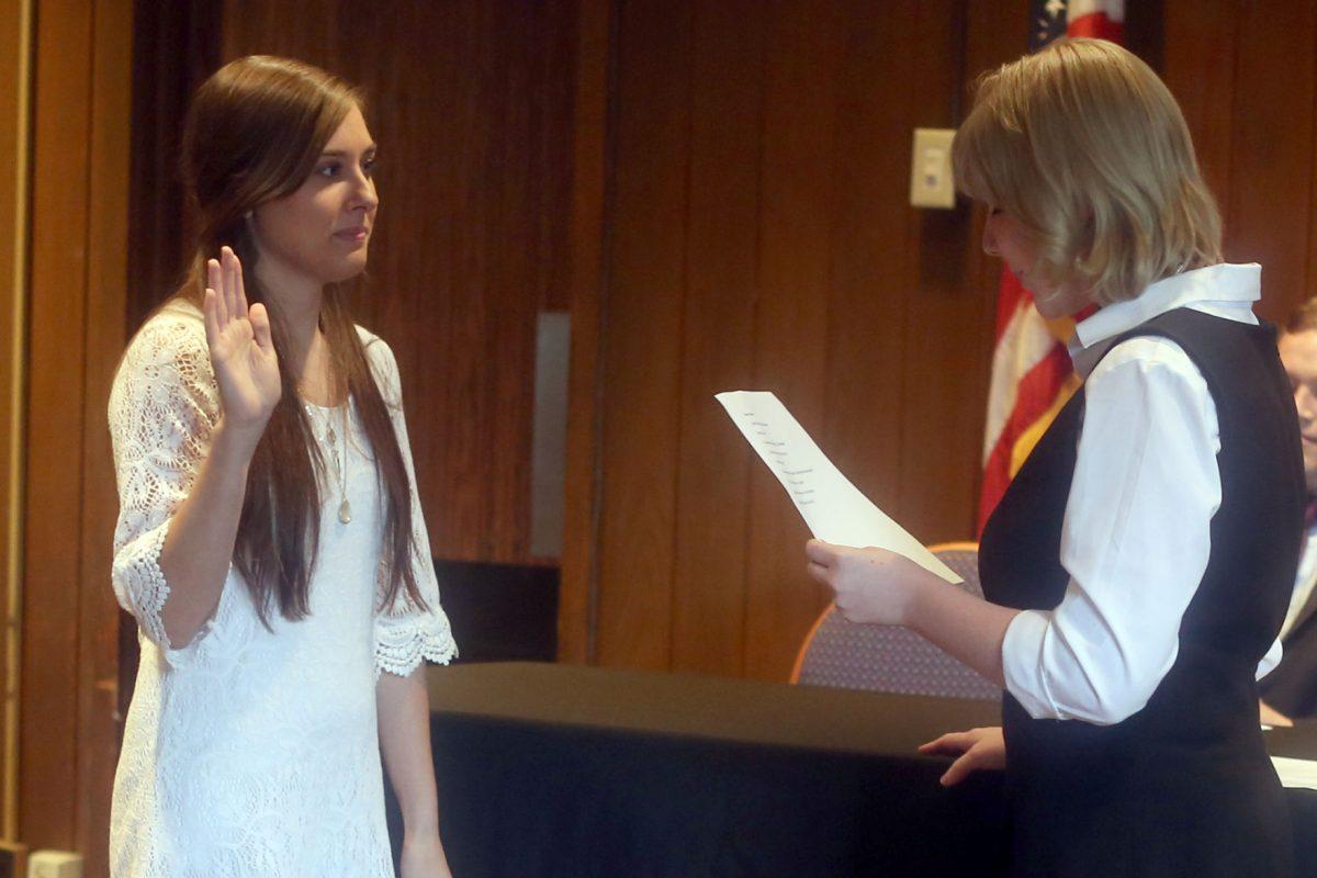 SGA President Kelsey Keny inducts Katelyn Hadder as the new Student Services Director on April 15 in the UC Hermitage Room.
