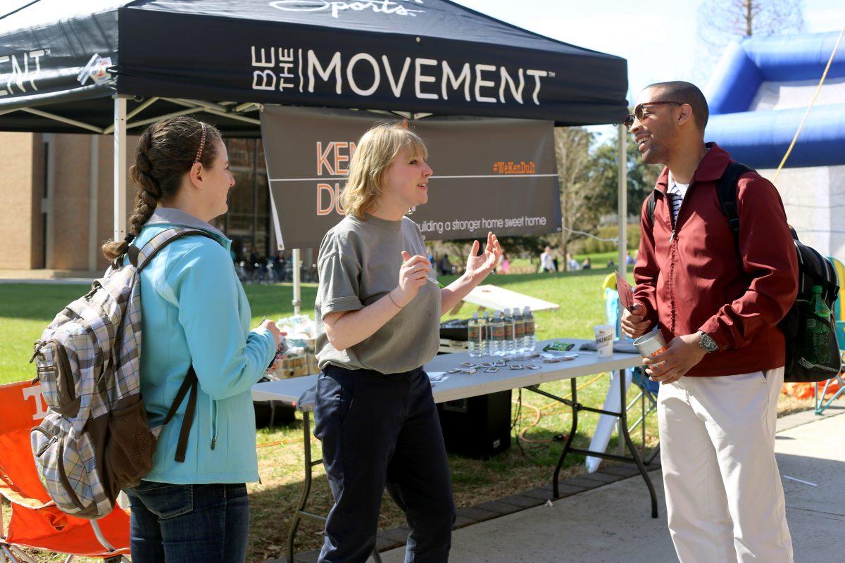 Kelsey Keny, junior in journalism and electronic media and SGA presidential candidate running on the Keny-Dugosh ticket, talks to students on Pedestrian Walkway on Monday.