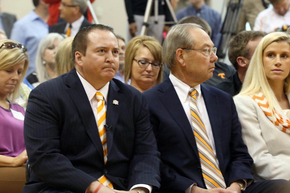 Donnie Tyndall, left, waits to be introduced as Tennessee's new men's basketball coach at Pratt Pavilion on April 22.